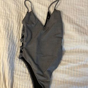 Black and white body suit with cut outs on side